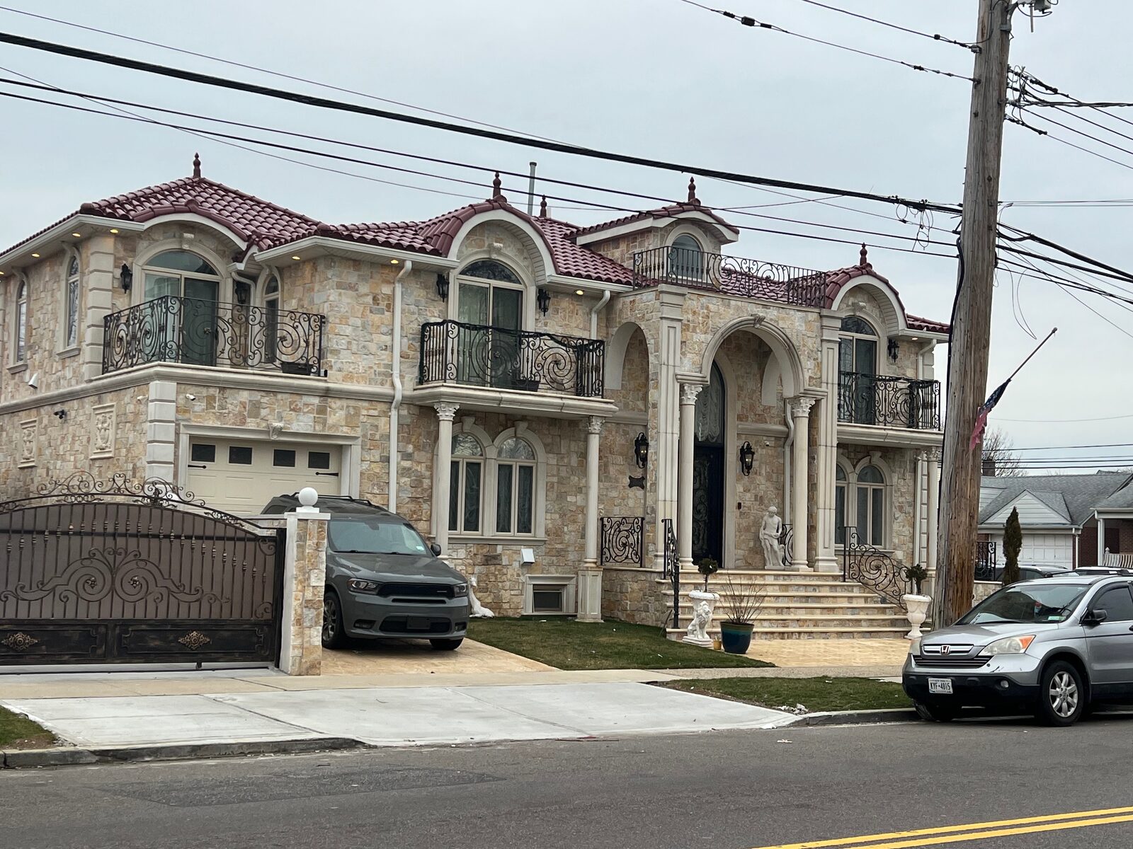 Symmetric red-brick mansion with gabled dormers and clay tile roof