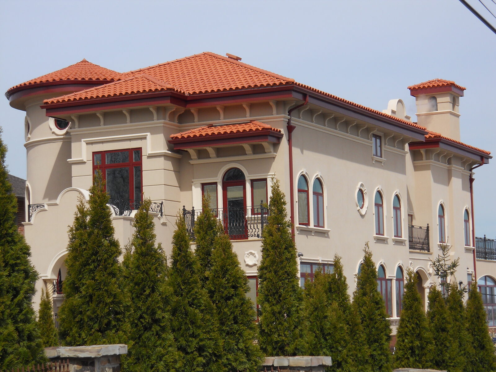 Cream Mediterranean villa with red clay tile roof