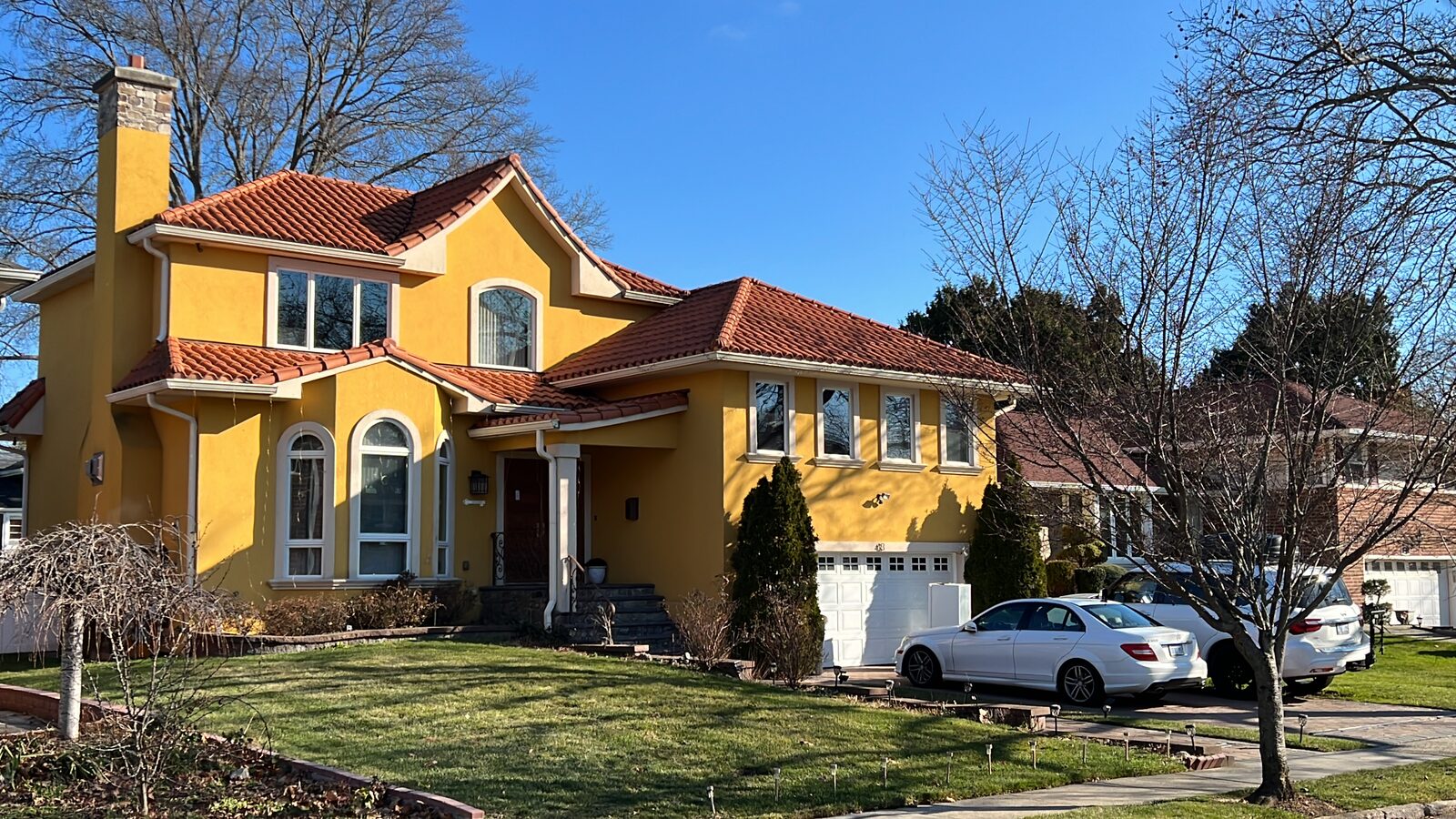 Golden-stucco home with red clay tile roof