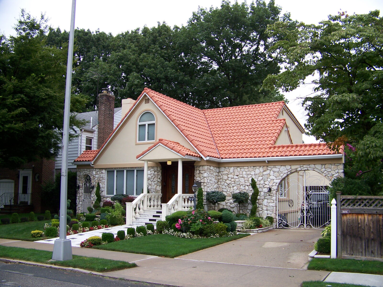 Stone-and-stucco home with red clay tile roof