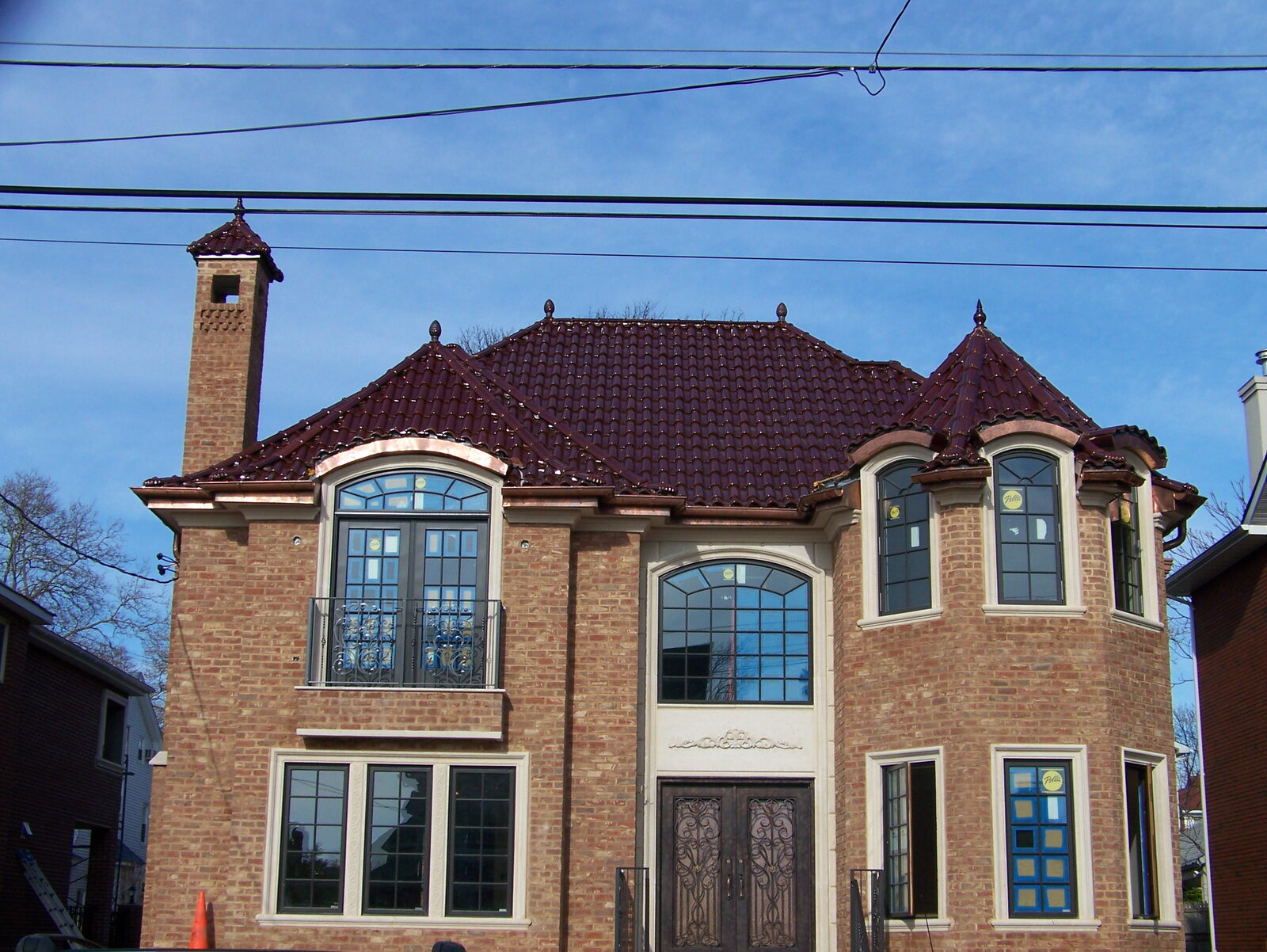 Brick home with red-domed turret and clay tile roof