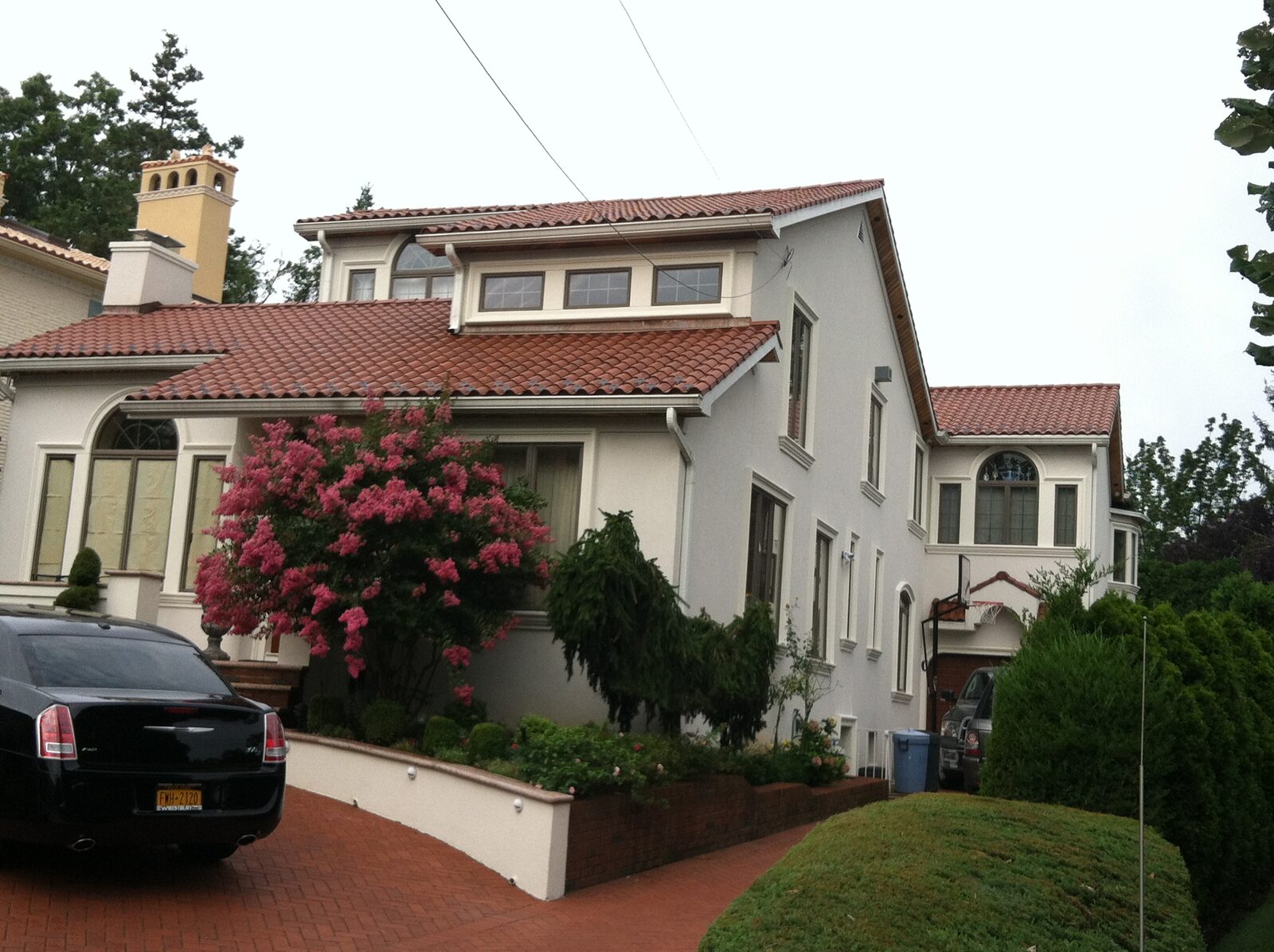 Stucco home with columns and red clay tile roof