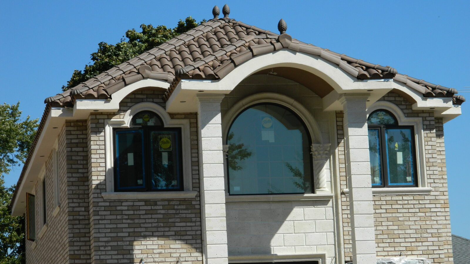 Stucco home with cupola and red clay tile roof