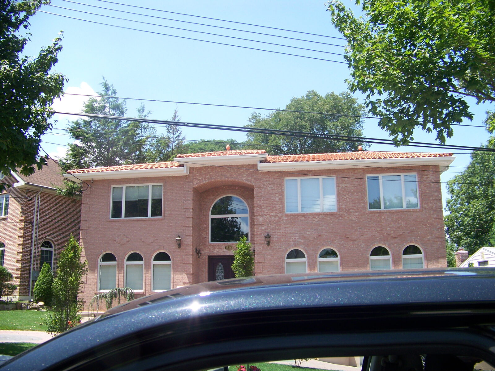 Brick home with rounded turret and clay tile roof