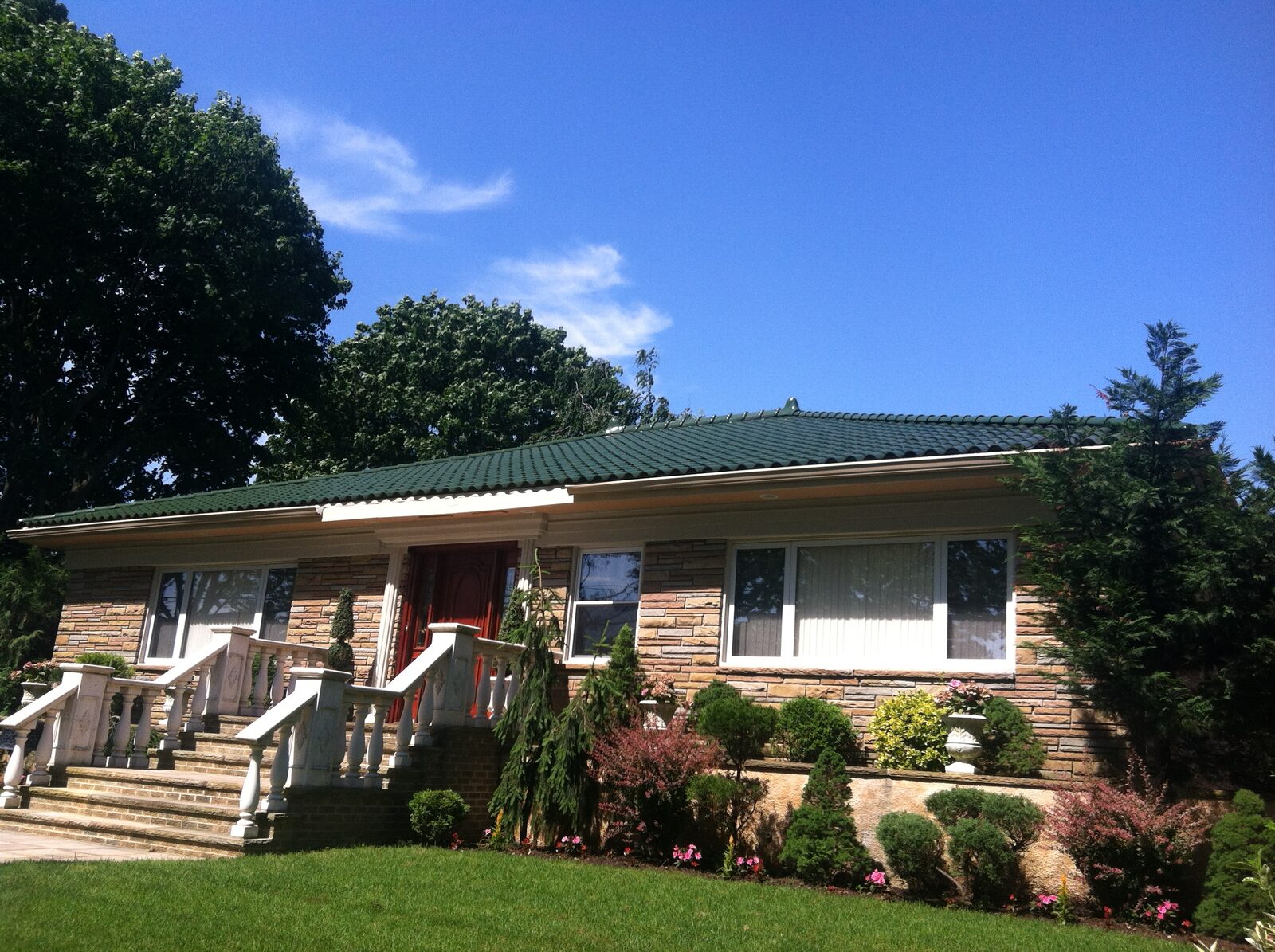 Shingled ranch home with green glazed clay tile roof