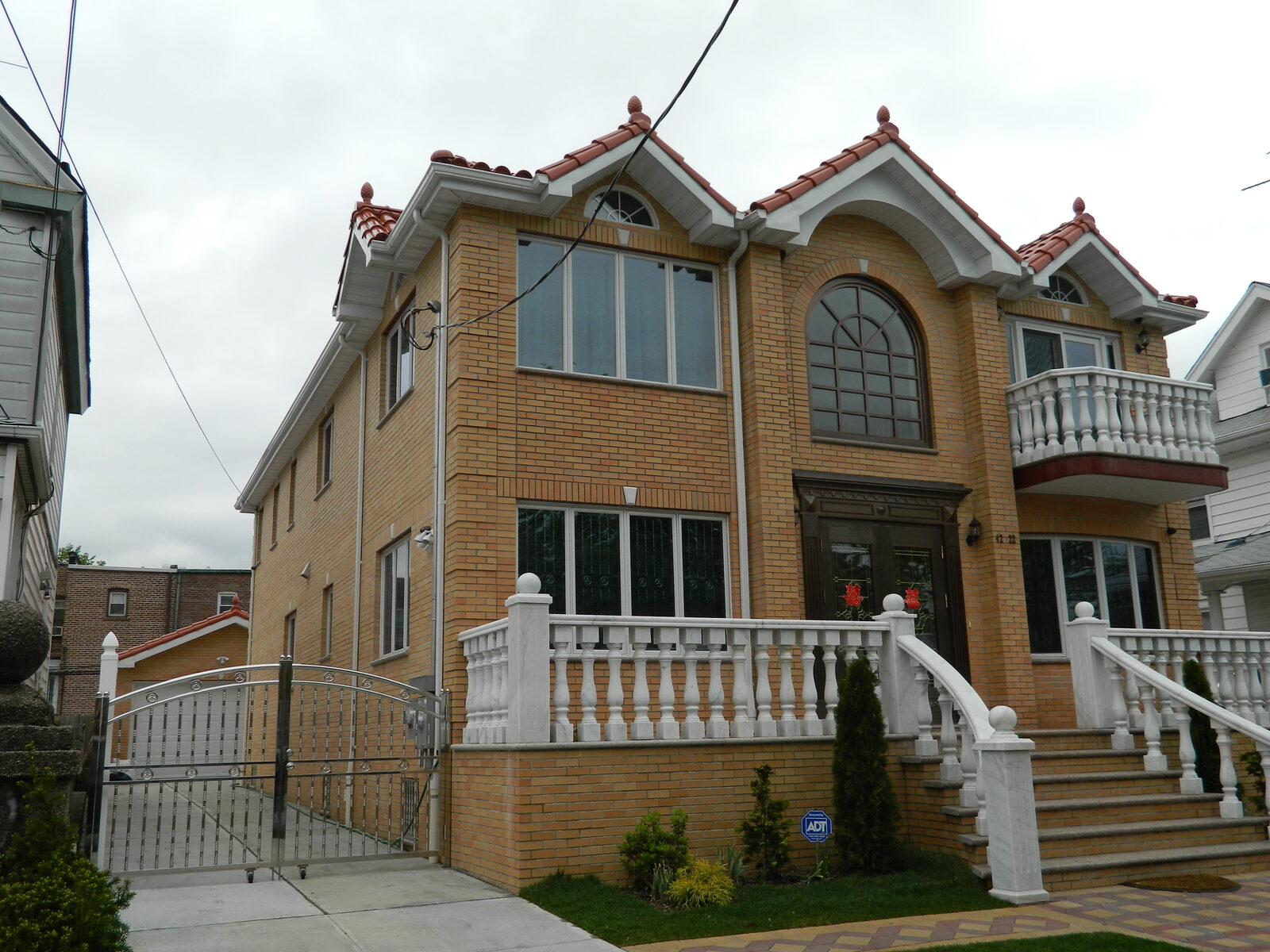 Two-story home with glazed clay tile roof