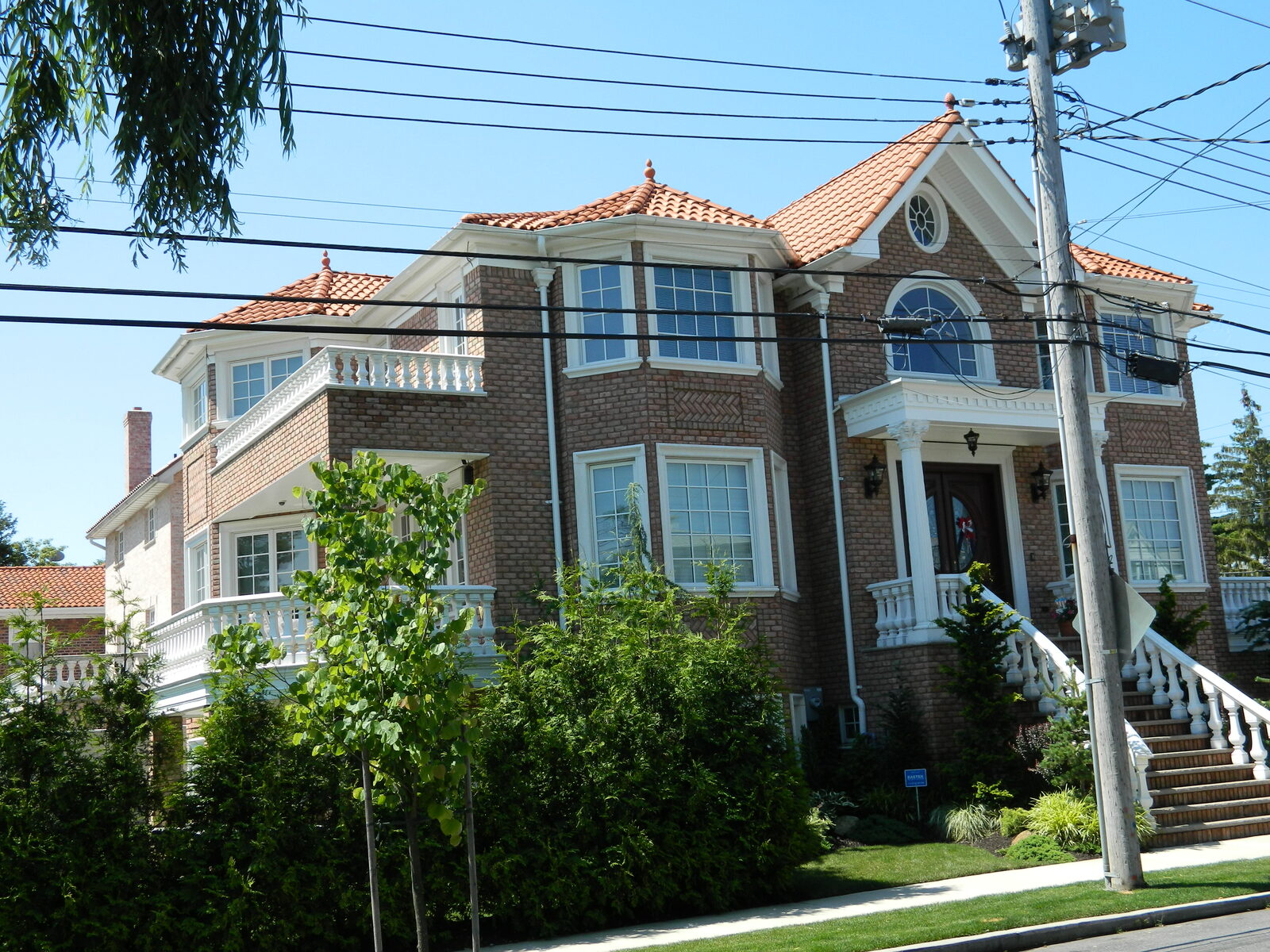 Grey-brick mansion with turret and red clay tile roof