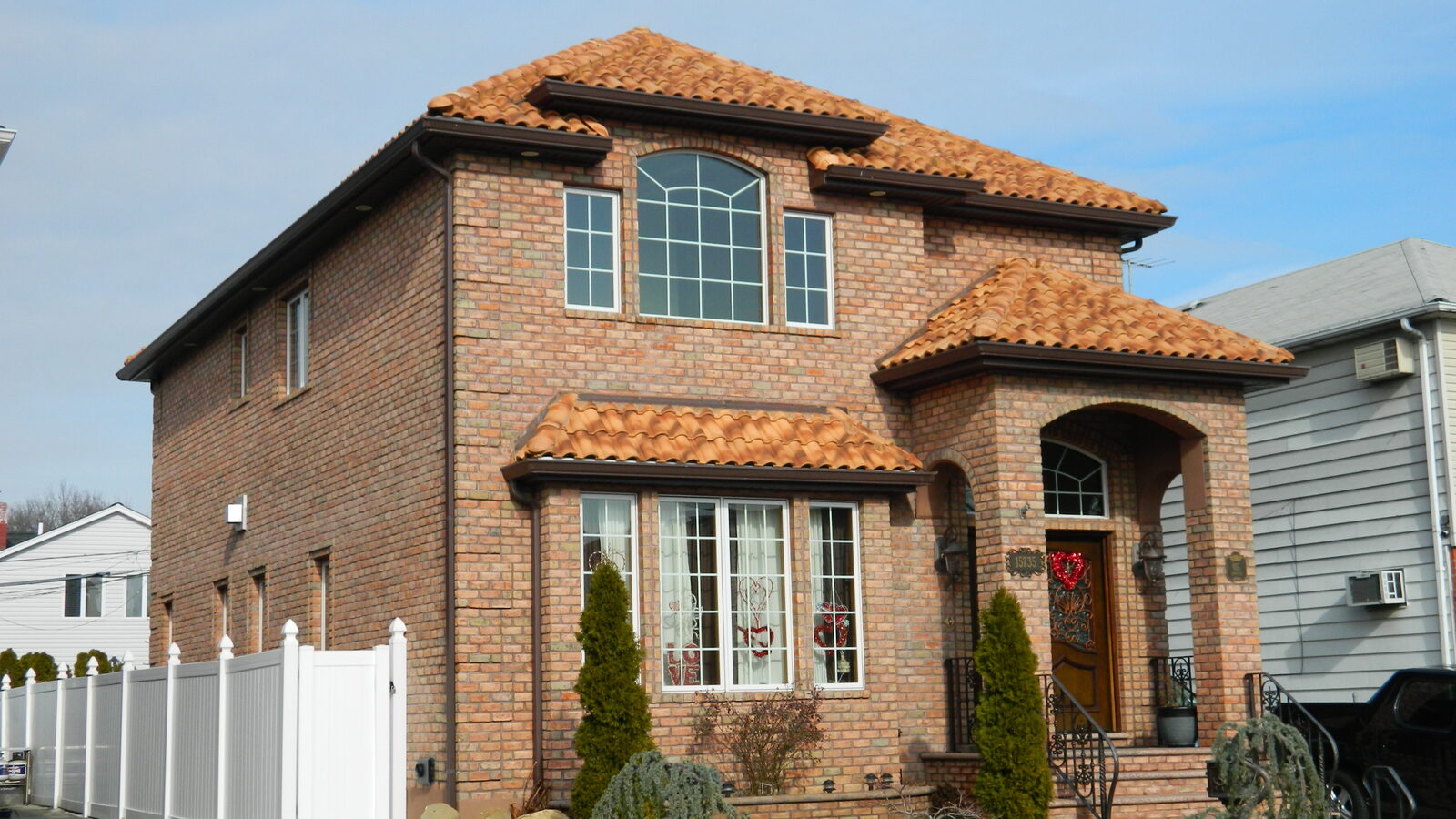 Brick home with turret and red clay tile roof