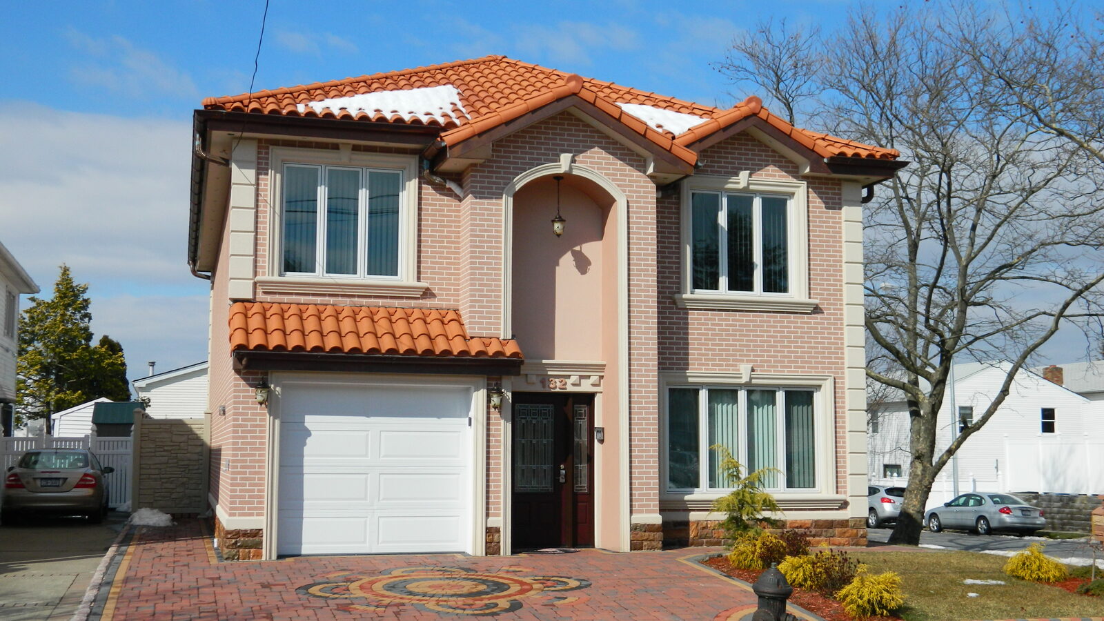 Brick home with red clay tile roof