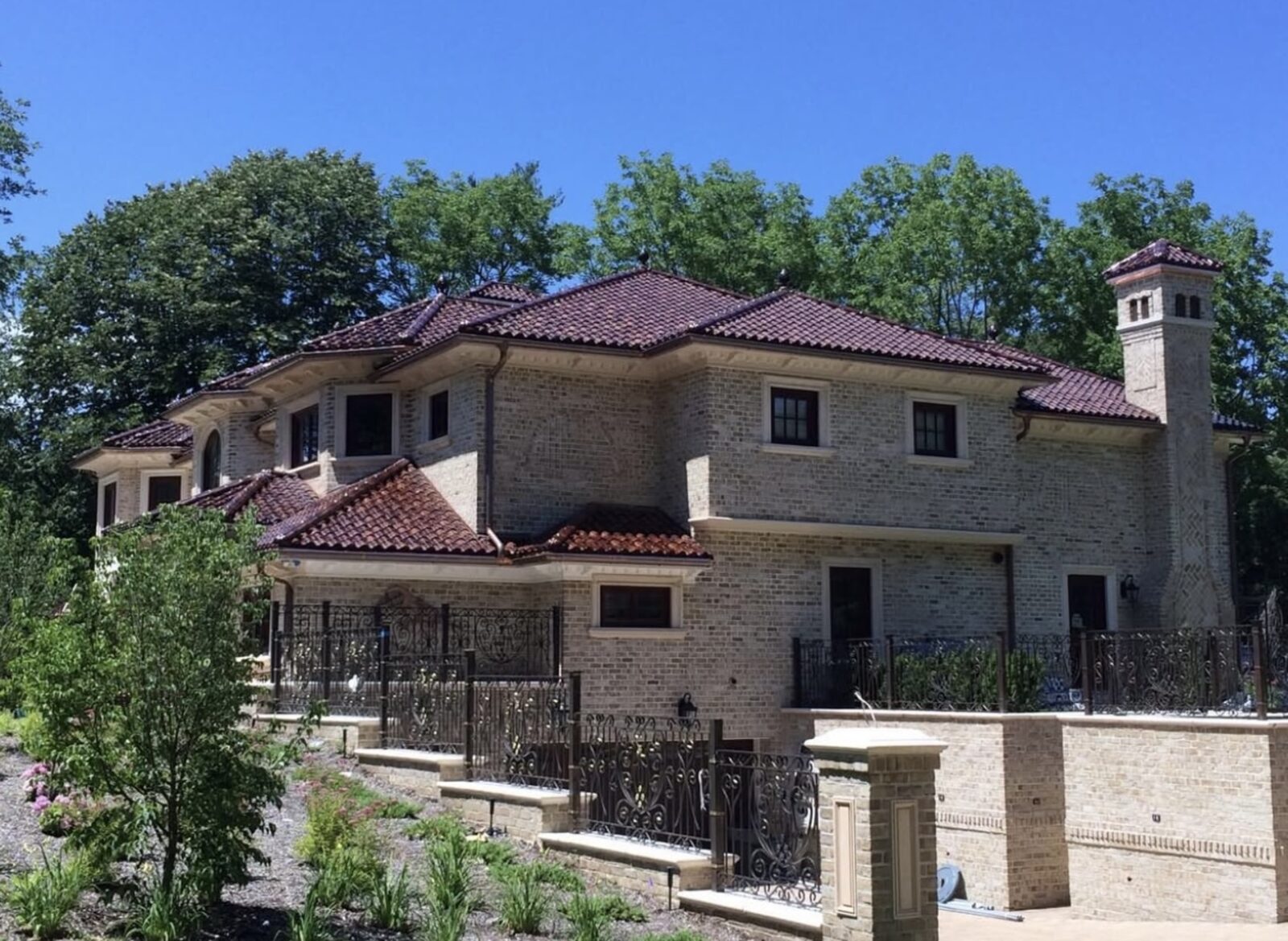 Luxury villa with turret and vintage-red barrel clay tile roof