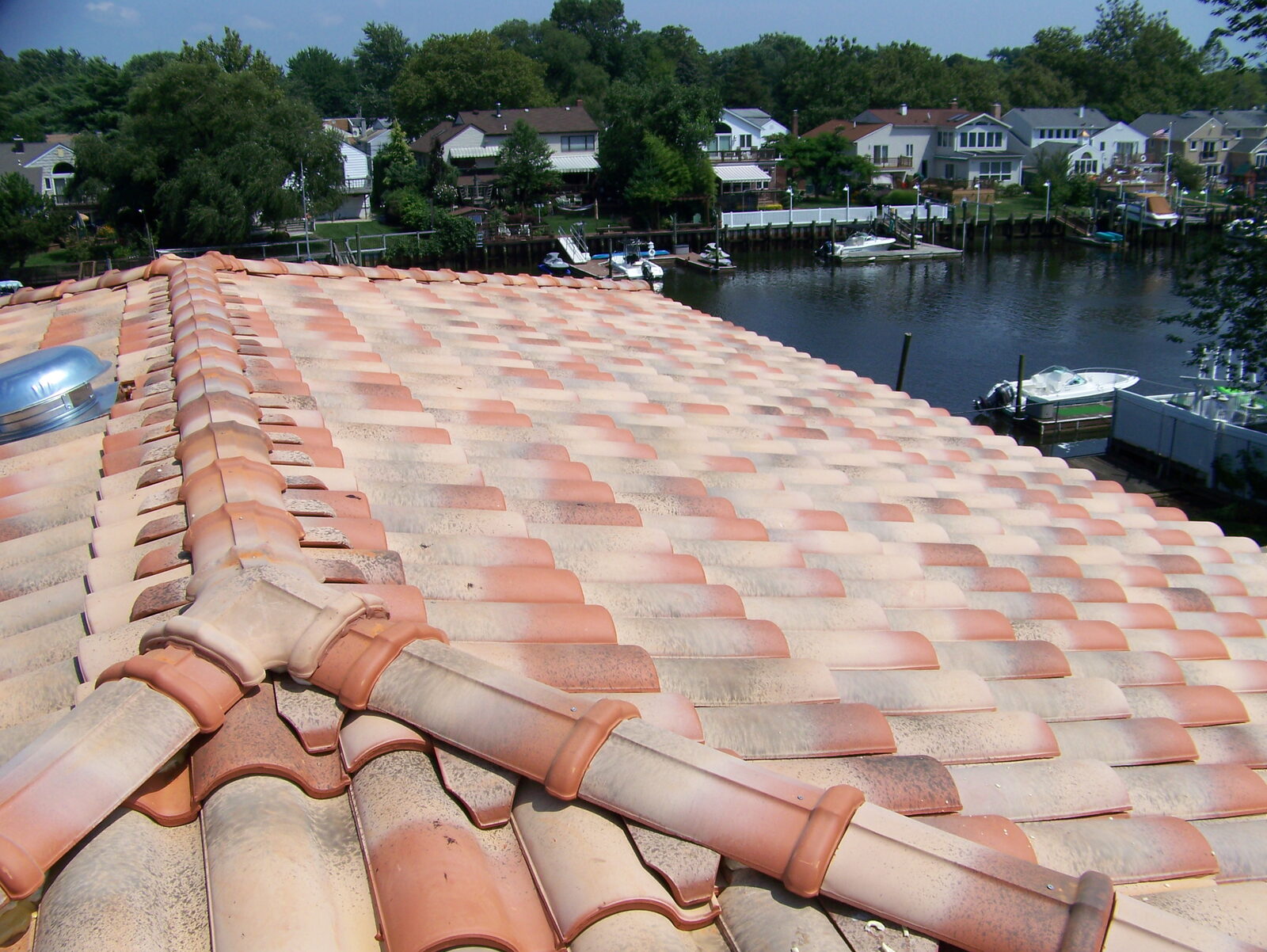 Multi-color Spanish barrel clay tile roof overlooking the water