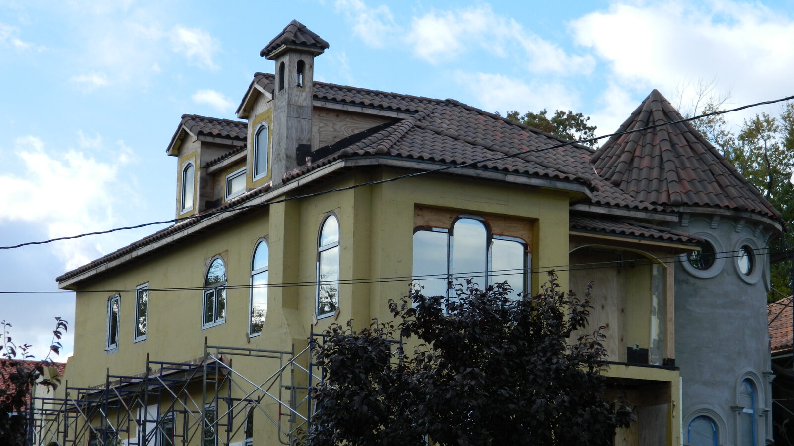 Cream Mediterranean home with clay tile roof