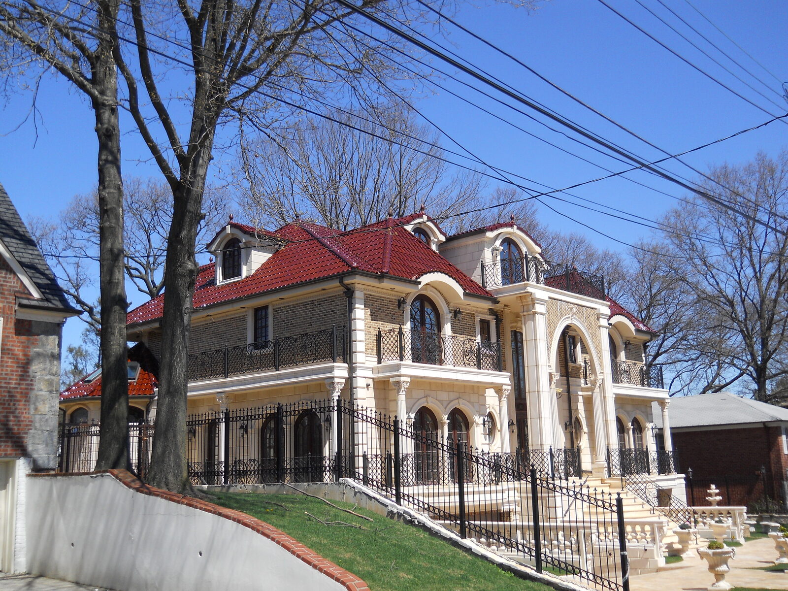 Cream stucco villa with arched loggia and terracotta clay tile roof