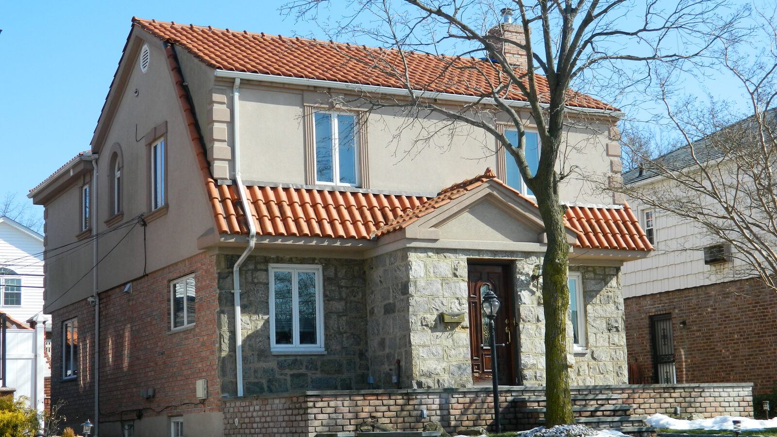 Cream stucco home with red clay tile roof