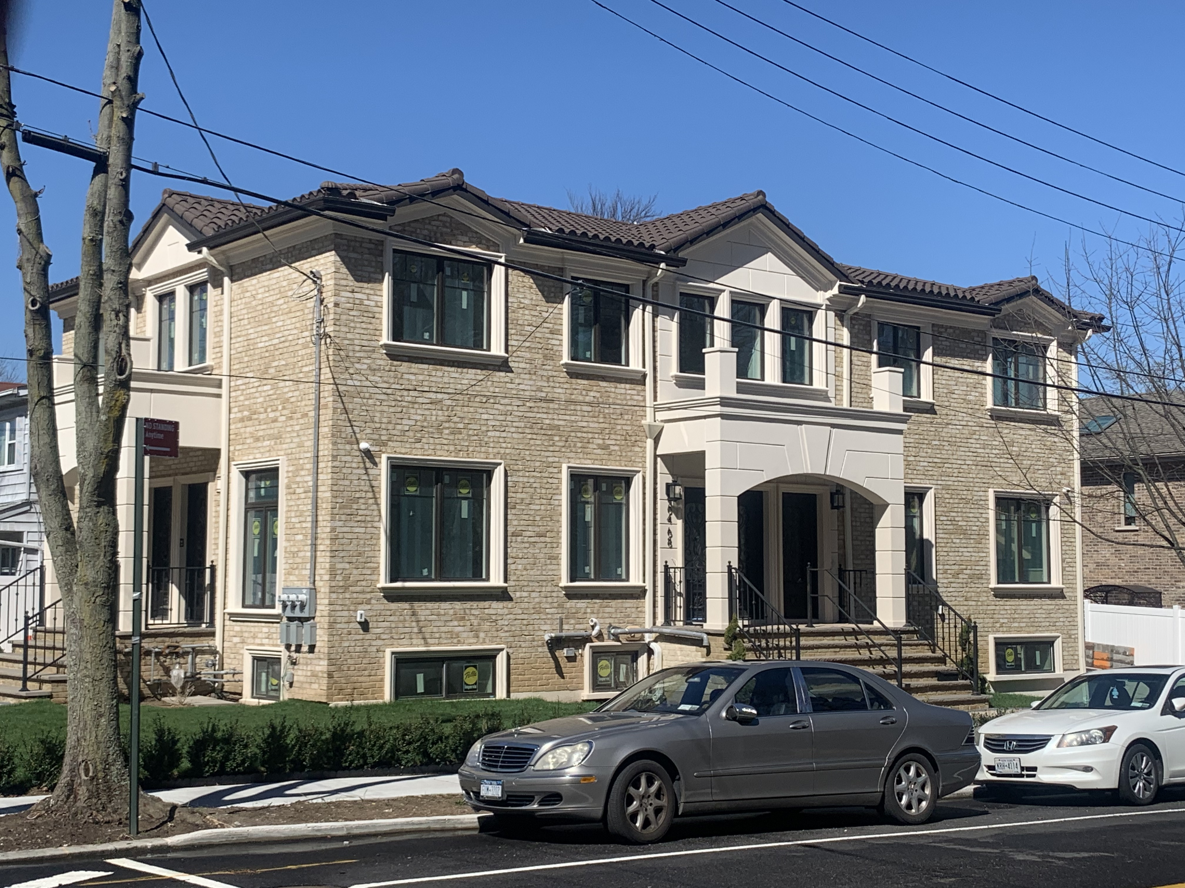 Modern two-story home with clay tile roof installation