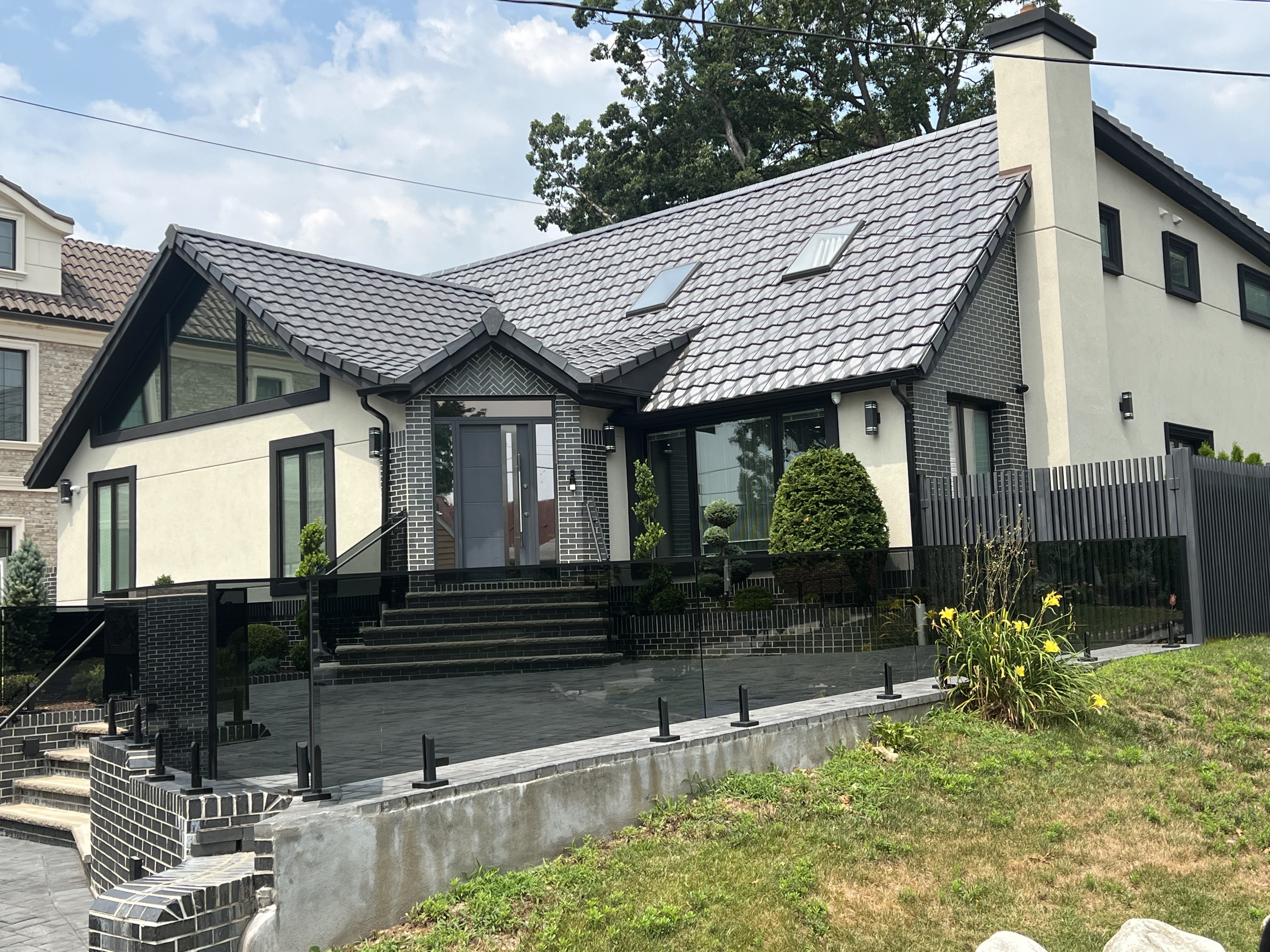 Contemporary home with modern design and gray clay tile roof