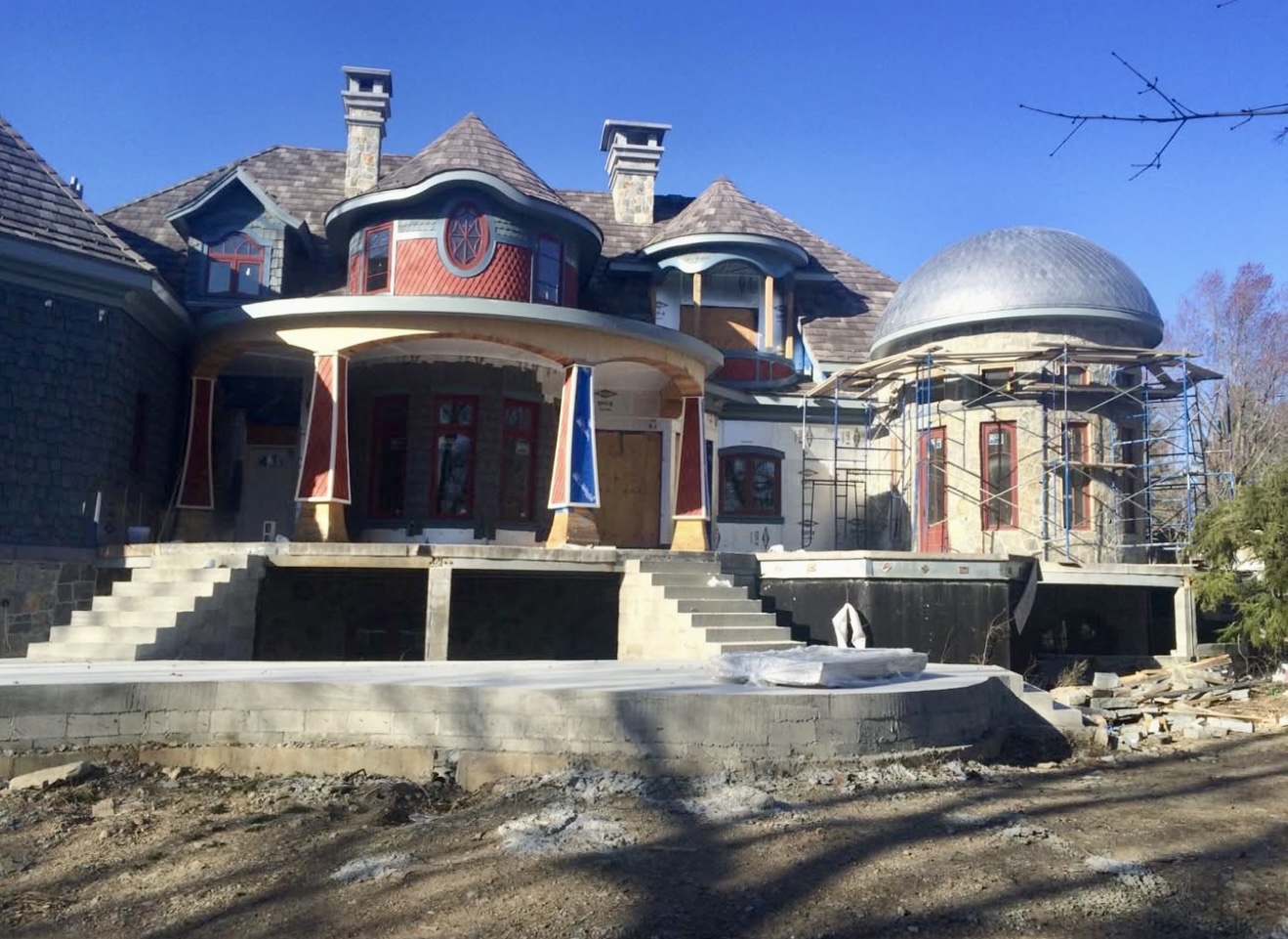 Front view of custom home with slate shake roof under construction