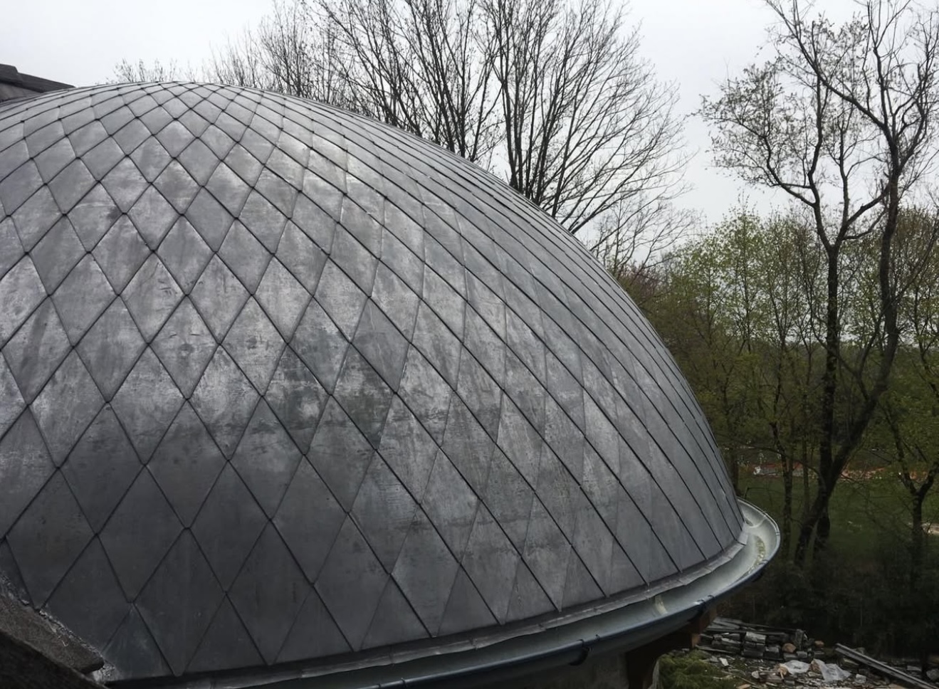 Detailed view of custom dome roof with diamond-patterned slate tiles